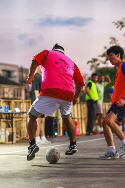 soccer player dribbling on concrete